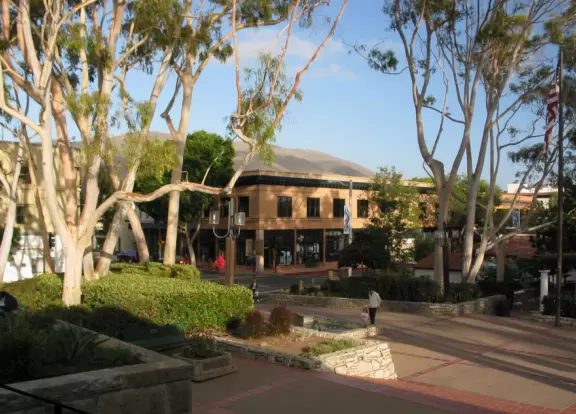 A main street of late 19th century storefronts, popular cafes, and a hip college scene. Recently, suffering an epidemic of homelessness relating to mental health problems.