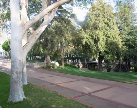 Spanish mission from late 18th century, in downtown San Luis Obispo, with giant roses in the garden behind and a lively plaza in front.