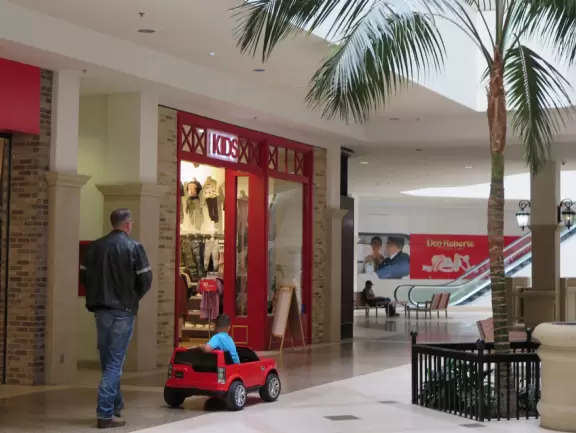 Indoor mall with Claire's, Macy's, Journeys shoe store, trampoline and arcade places, and a movie theater. Cars for kids.
