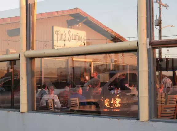 A glorious beach in Grover Beach town, with sand dunes and a wooden boardwalk, plus an octagon-shaped wooden pier in the sand.