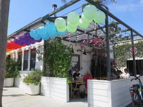 Hip area with wine bars, cafes, and bakeries, where you can sit on a patio surrounded by ivy-covered walls.