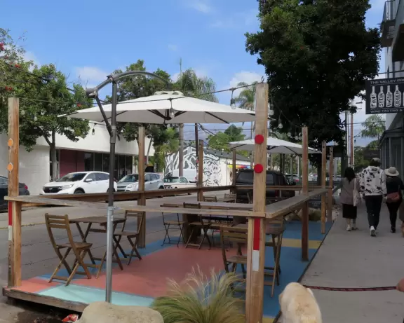 Hip area with wine bars, cafes, and bakeries, where you can sit on a patio surrounded by ivy-covered walls.