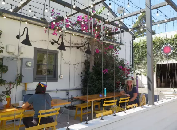 Hip area with wine bars, cafes, and bakeries, where you can sit on a patio surrounded by ivy-covered walls.