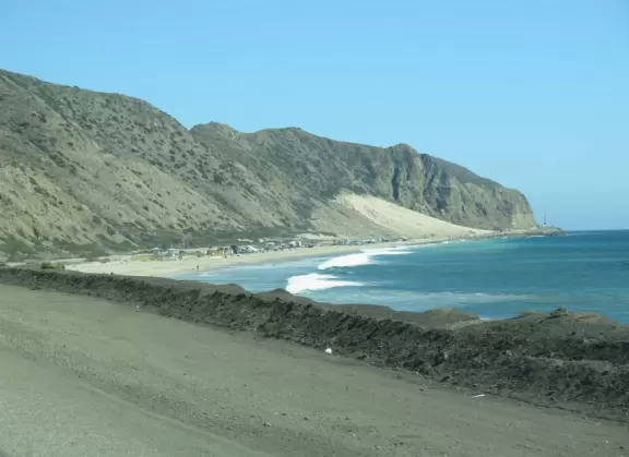 Huge sand dune along Highway 1, plus rock cairns along the ocean across the street.