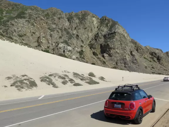Huge sand dune along Highway 1, plus rock cairns along the ocean across the street.