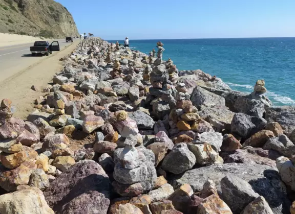 Huge sand dune along Highway 1, plus rock cairns along the ocean across the street.