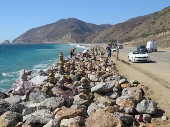 Huge sand dune along Highway 1, plus rock cairns along the ocean across the street.