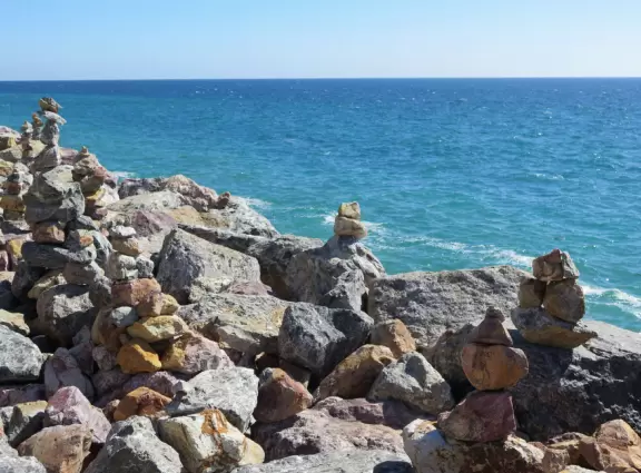 Huge sand dune along Highway 1, plus rock cairns along the ocean across the street.