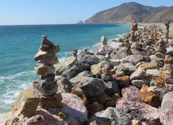 Huge sand dune along Highway 1, plus rock cairns along the ocean across the street.