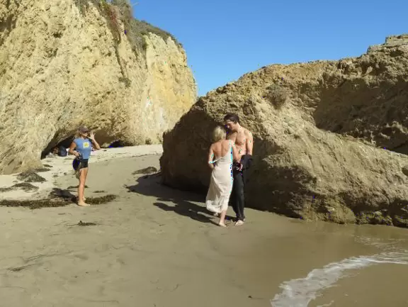 Incredible beach with blue-green water, rocks jutting out of the sea, arches, and caves.