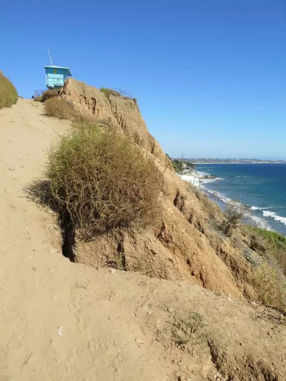 Incredible beach with blue-green water, rocks jutting out of the sea, arches, and caves.