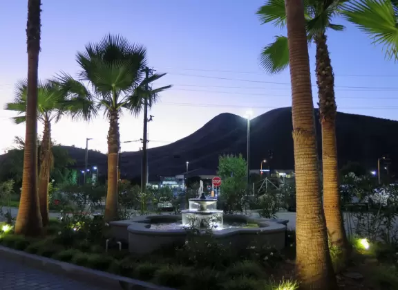 A shopping plaza with sidewalks cafes and shops that would look like Europe if it weren't so new!
