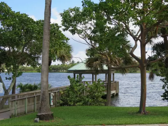 Playground by a lake with ibis birds, turtles, and a walking path.