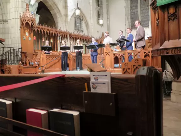 Delightful garden behind a gothic church, with lily pond, koi fish, tropical flowers, sculpted coral walls, fountain, and fresco.