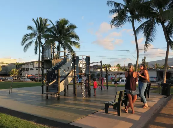 Sweet little beach with steep golden sand, shallow calm water, and a great playground and park full of people!