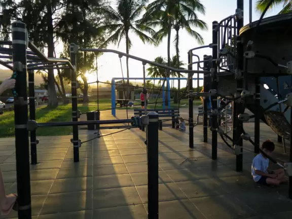 Sweet little beach with steep golden sand, shallow calm water, and a great playground and park full of people!