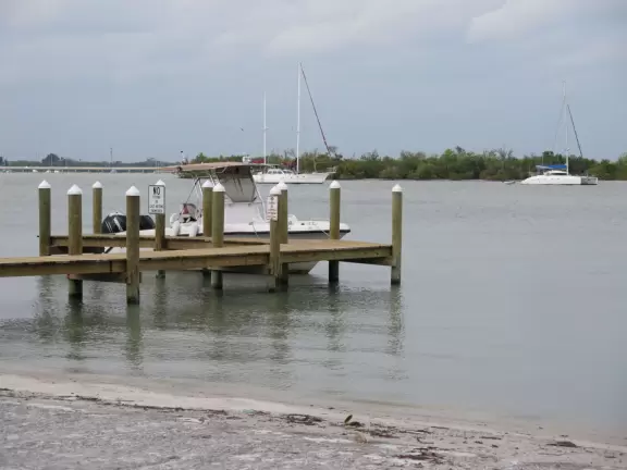 Beautiful area with white sand beach on turquoise river, playground, and small well-cared-for aquarium.