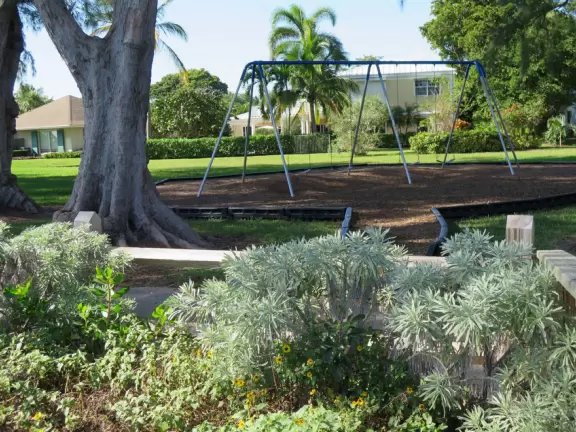 Gorgeous park with white sand beaches, ironwood trees, beach sunflowers, playground, basketball, and a pretty walkway.
