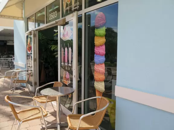 Beach with everything a beach should have: pale sand, aquamarine water, coconut palms, dunes, fit people, and cafes.