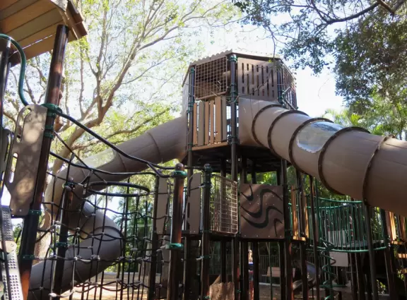 Magical spot with white sand beach on the river, coconut trees galore, views of the Ernest Lyons Bridge, and shady playground with tall, tall slides!