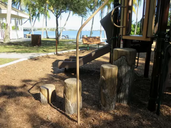 Magical spot with white sand beach on the river, coconut trees galore, views of the Ernest Lyons Bridge, and shady playground with tall, tall slides!