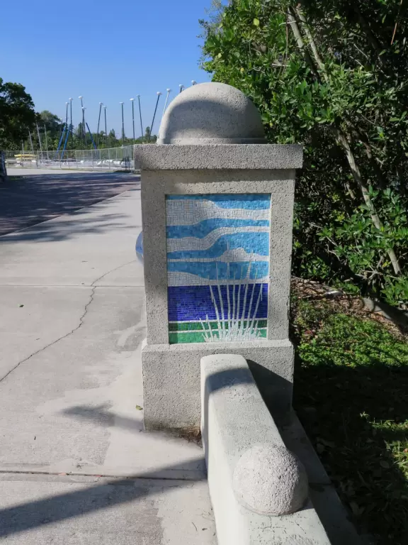 Popular 1.7 mile loop walking path with some shade and wooden boardwalk beside the river.