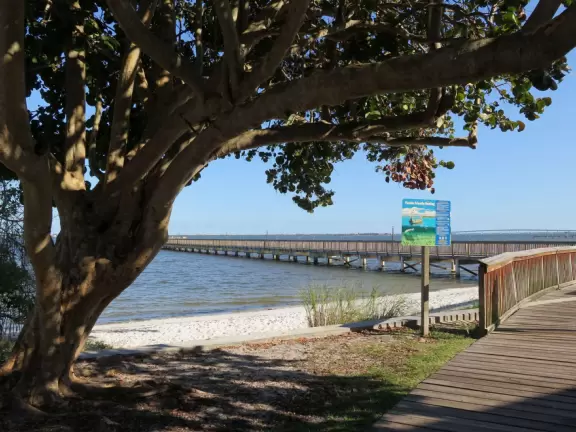 Popular 1.7 mile loop walking path with some shade and wooden boardwalk beside the river.