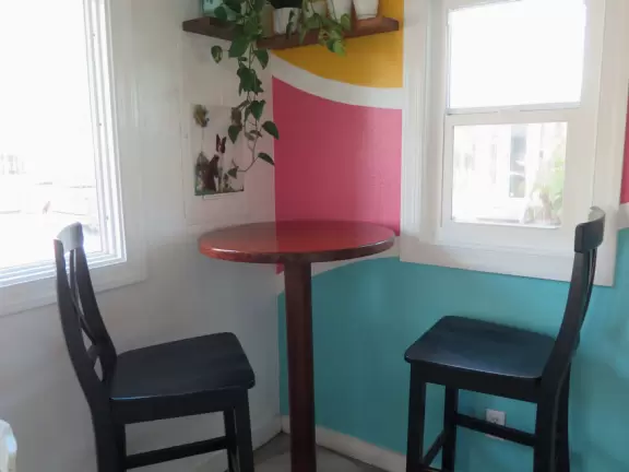 Main block with tropical-themed cafes and views of the water, plus a coffee shop and gift shops in little houses.