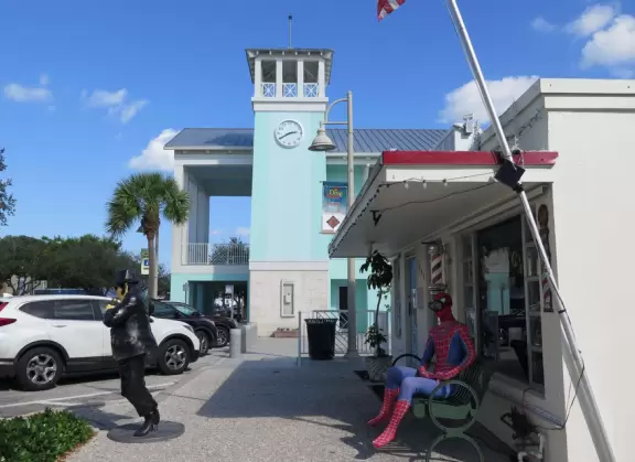 Main block with tropical-themed cafes and views of the water, plus a coffee shop and gift shops in little houses.