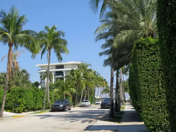 Lovely spot with long pool fountain, horse fountain, and European chairs under hedges.