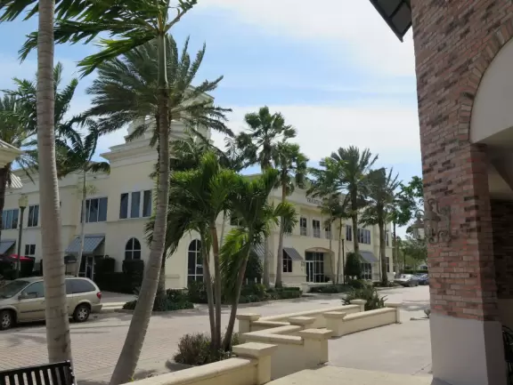 Town with splash pad on the lake, town square with cafes, playground, and lots of stores.