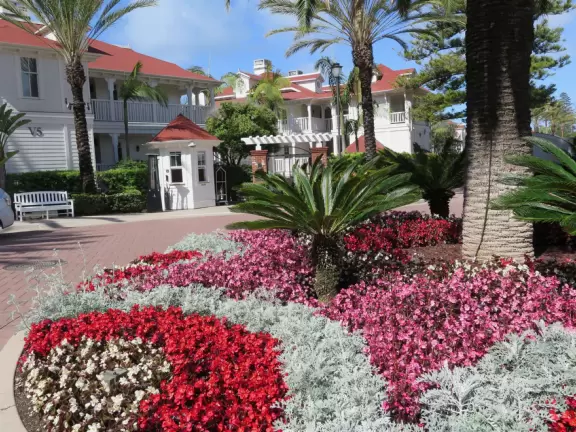 Historic resort with red turrets on foggy beach of fine white sand.