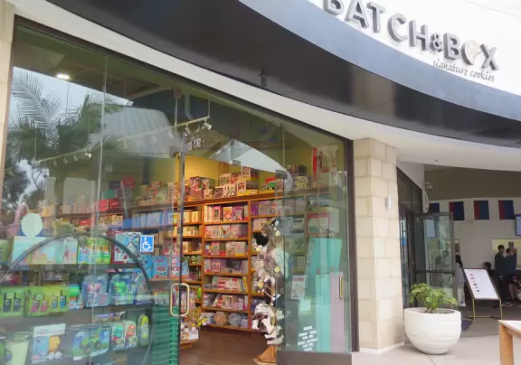 Shopping plaza with a deck offering lots of attractive public space, a trampoline for young kids, a sky deck bar, a dark public market with lights, cafes, stores and coffee shops.