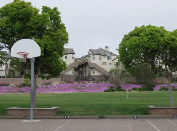 On weekends and after school, residents walk and play at the school playground.
