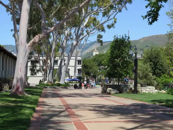 Spanish mission from late 18th century, in downtown San Luis Obispo, with giant roses in the garden behind and a lively plaza in front.