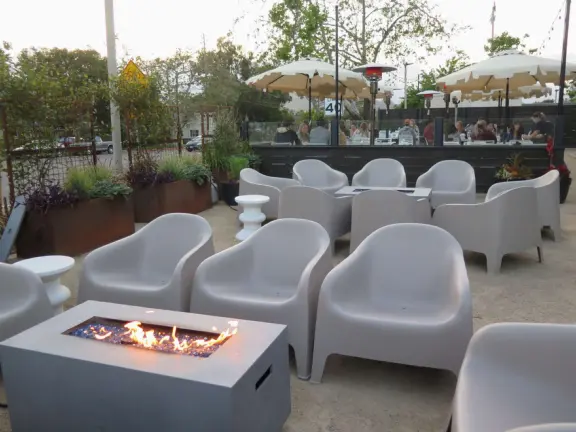 Trendy area with coffee shop, beer garden, wine bars, and cider bar, in industrial-style architecture with murals.