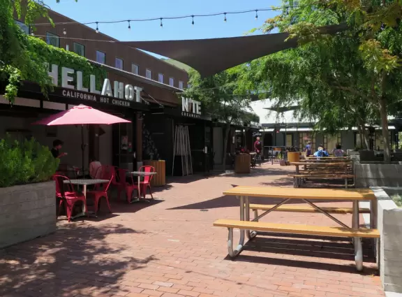 A main street of late 19th century storefronts, popular cafes, and a hip college scene. Recently, suffering an epidemic of homelessness relating to mental health problems.