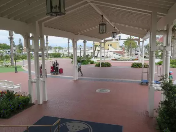 Historic resort with red turrets on foggy beach of fine white sand.