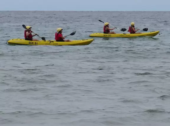 Beach with boardwalk, playground, magical mansion, and kayak rentals to kayak to sea caves, plus cafes nearby.