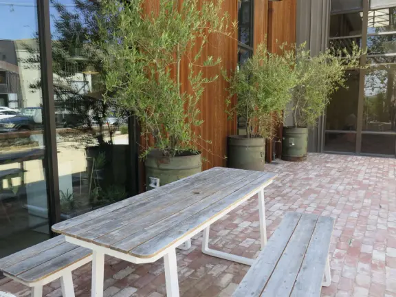 Trendy area with coffee shop, beer garden, wine bars, and cider bar, in industrial-style architecture with murals.