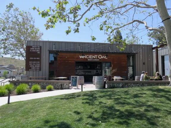 Trendy area with coffee shop, beer garden, wine bars, and cider bar, in industrial-style architecture with murals.