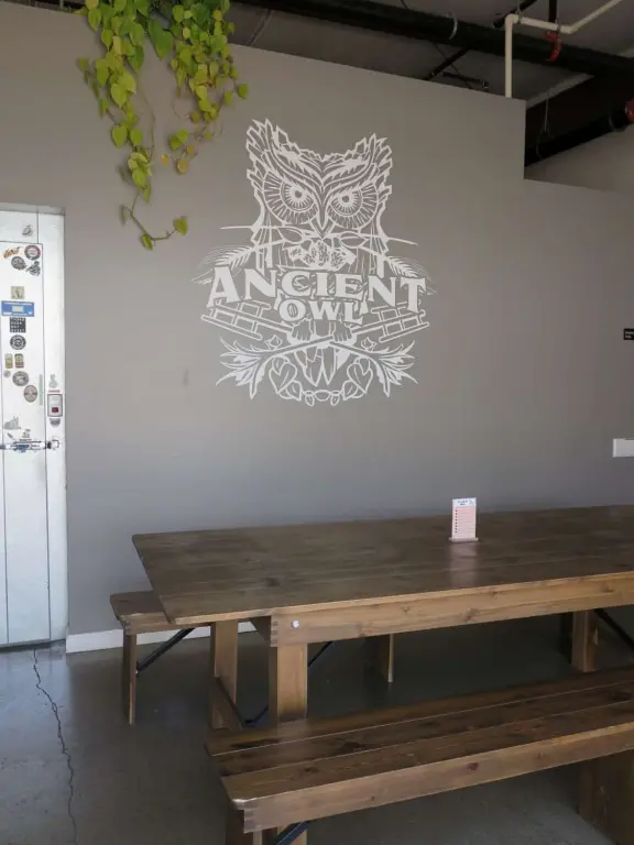 Trendy area with coffee shop, beer garden, wine bars, and cider bar, in industrial-style architecture with murals.