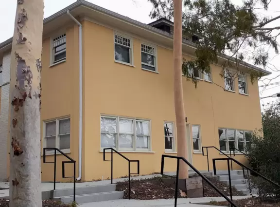 A main street of late 19th century storefronts, popular cafes, and a hip college scene. Recently, suffering an epidemic of homelessness relating to mental health problems.