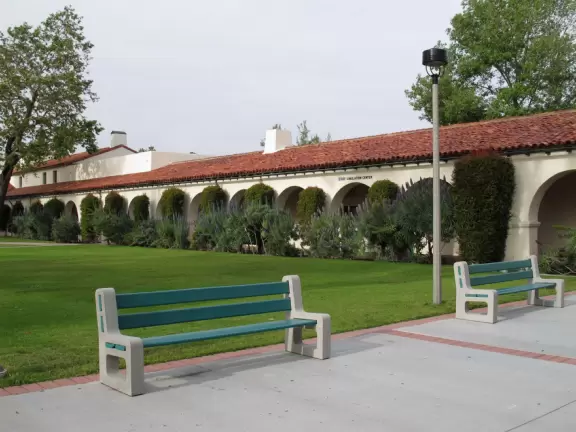 Modern campus with tropical blooming trees and Spanish architecture on the northern end of campus.