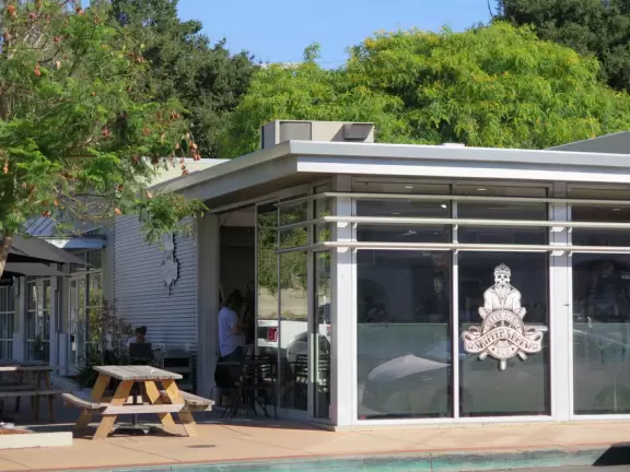 A main street of late 19th century storefronts, popular cafes, and a hip college scene. Recently, suffering an epidemic of homelessness relating to mental health problems.