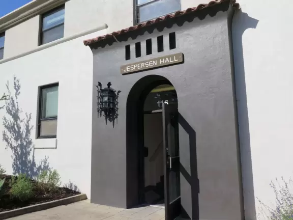 Hilly, sunny campus with tall, impressive trees and green lawns. A hands-on learning university.