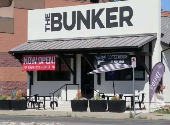 Trendy area with coffee shop, beer garden, wine bars, and cider bar, in industrial-style architecture with murals.