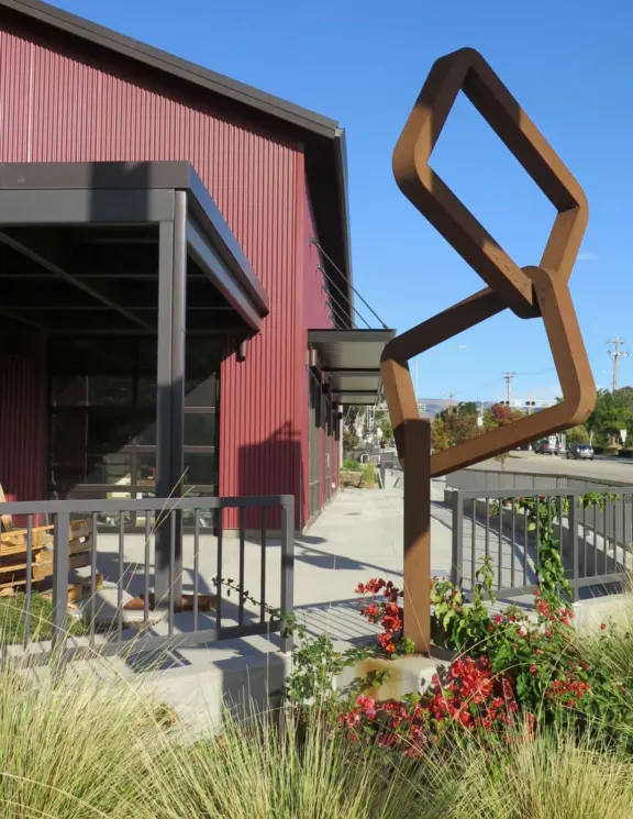 Trendy area with coffee shop, beer garden, wine bars, and cider bar, in industrial-style architecture with murals.