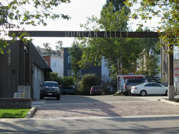 Trendy area with coffee shop, beer garden, wine bars, and cider bar, in industrial-style architecture with murals.