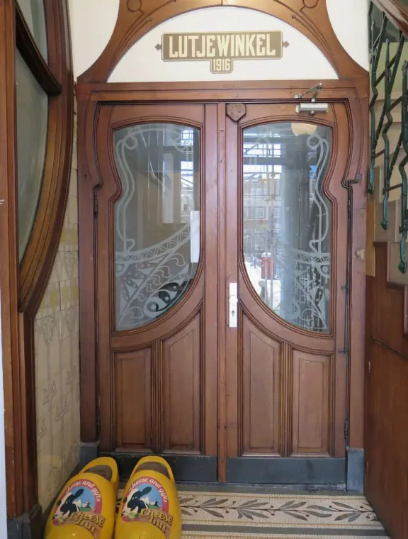 Flowers on bridges over canals, leafy outdoor seating at cafes, bustling streets, interesting museums, gingerbread architecture.